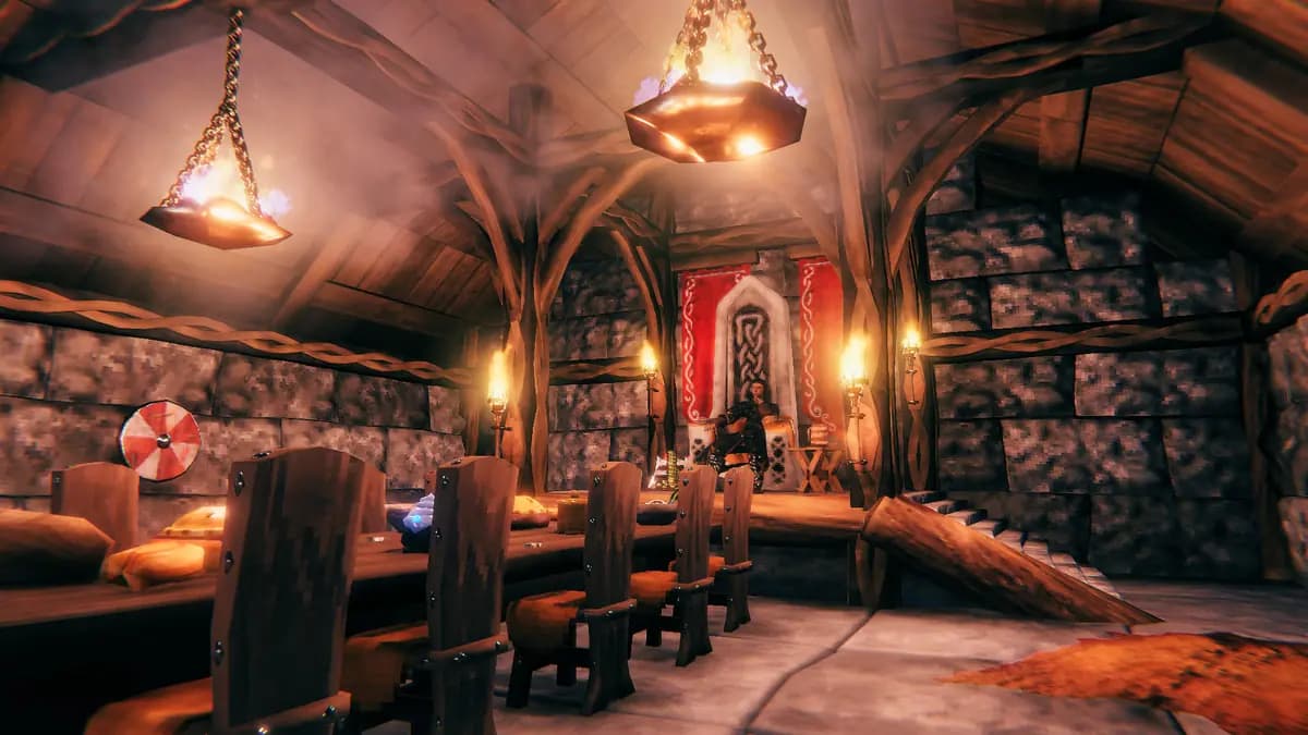 A Valheim longhouse hall lit by lanterns, with a long table set for a crew