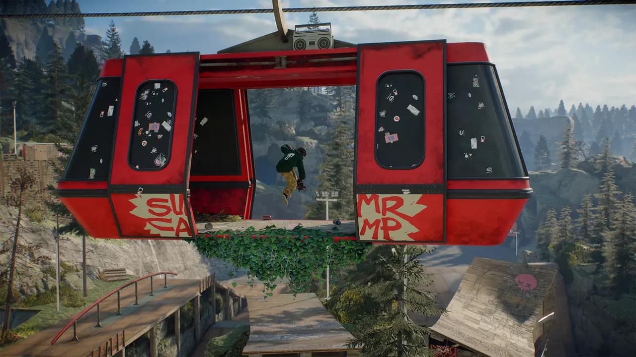 A skater riding through a red gondola cabin hung above a skate park
