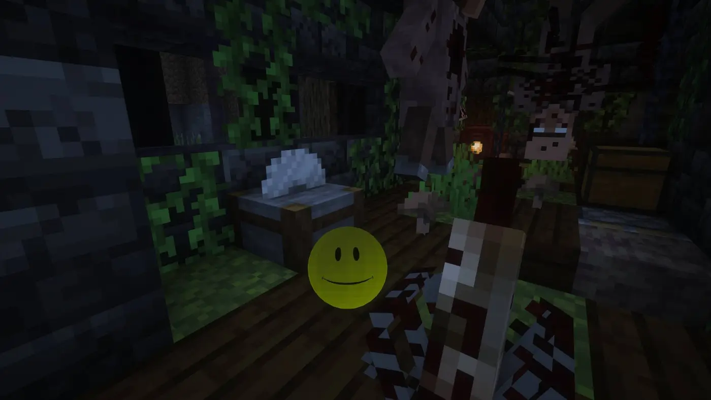 A dark ruined interior in VerityCraft, lit by one torch, with an eerie yellow smiley watching from the floor